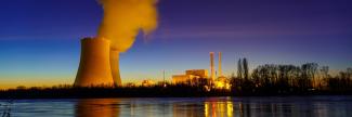 A saturated photo of a nuclear plant on the horizon.