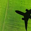 stock image of a shadow of an airplane over a field